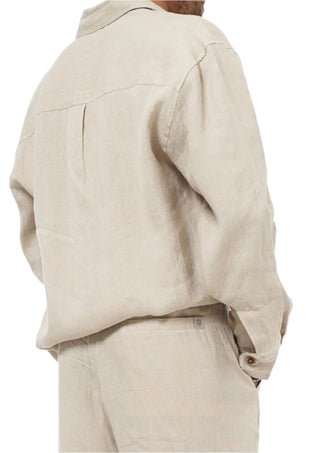 Beige jacket and pants worn by a person on a white background