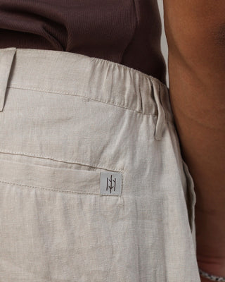 Beige pants with a brand Everseason logo on the pocket against a neutral background