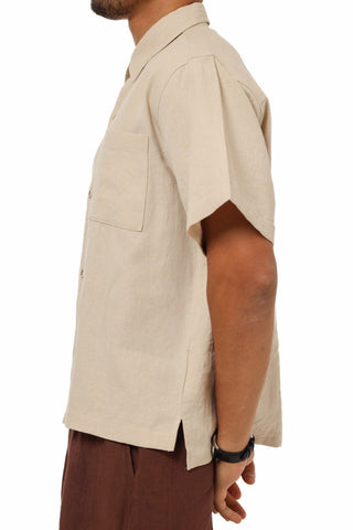 Person wearing a beige Everseason short-sleeve shirt on a white background