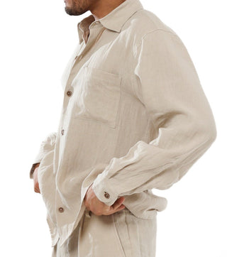 Man wearing a beige 100% linen button up shirt  on a white background