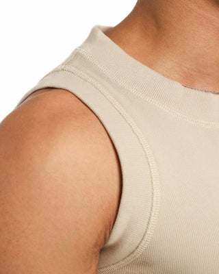 Close-up of a beige sleeveless Everseason top on a person with a white background