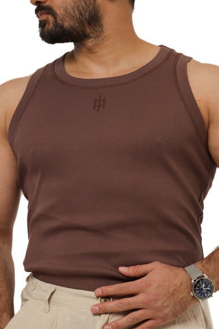 Man wearing a brown Everseason tank top with a logo on a white background